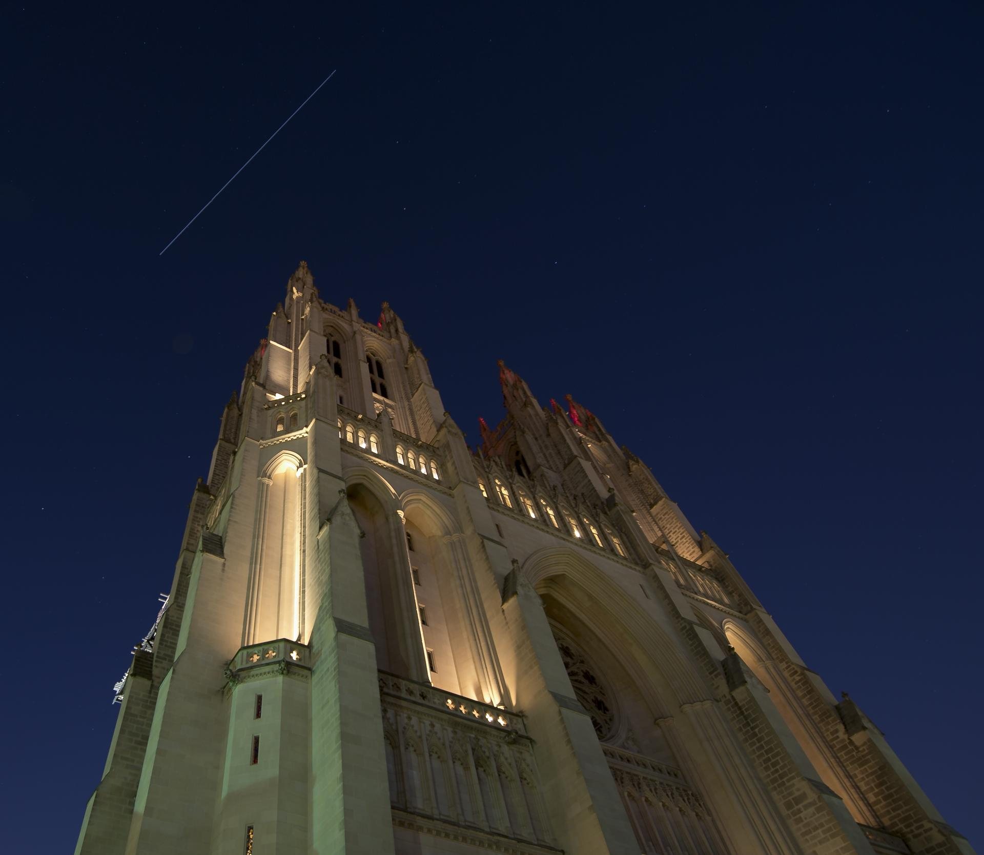 A long bright streak, the International Space Station in a twenty-second exposure, arcing over the Washington National Cathedral at night on November 29, 2017. NASA photograph.